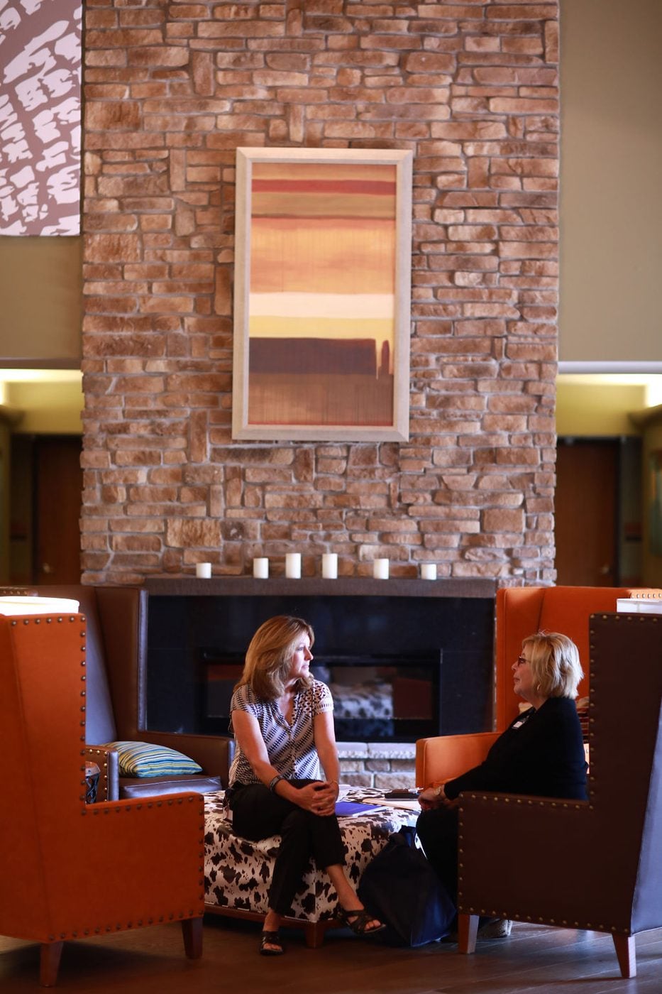 Two people seated in conversation at Sibcy House